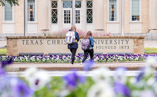 Students walking in front of TCU library